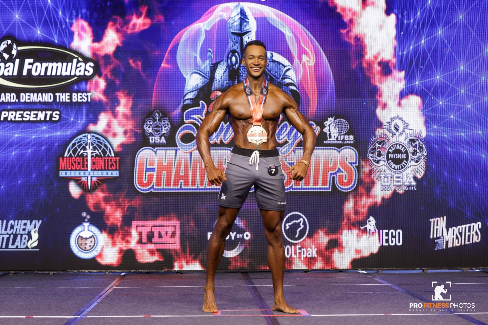 Quest on stage at a physique competition
