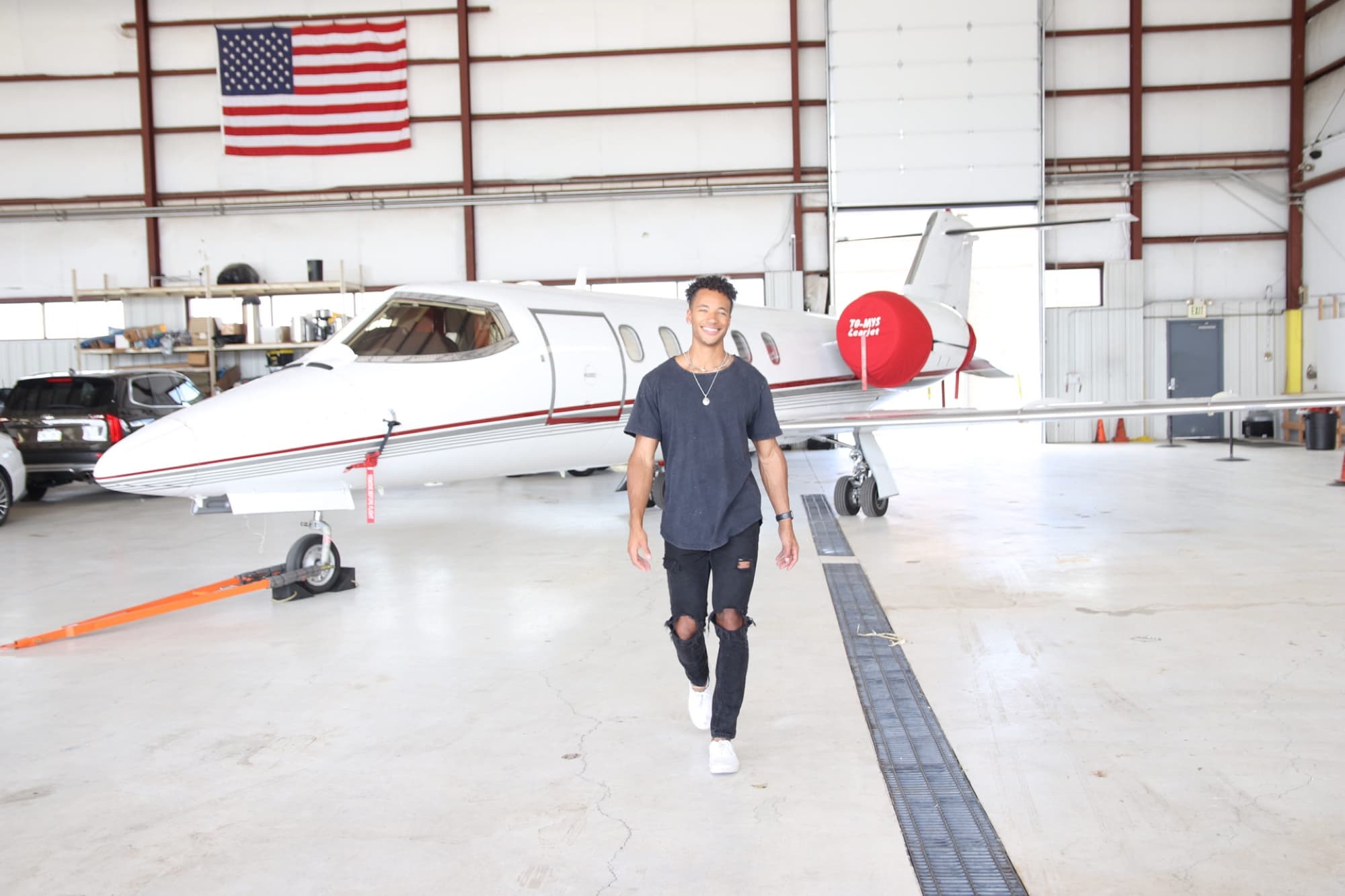 Quest walking through an aircraft hangar